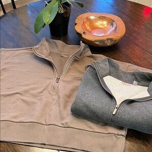 Two Zellla half-zip sweatshirts